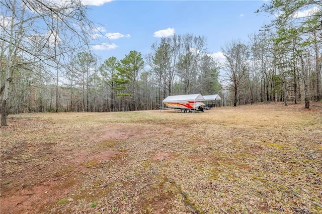 view of yard featuring a forest view