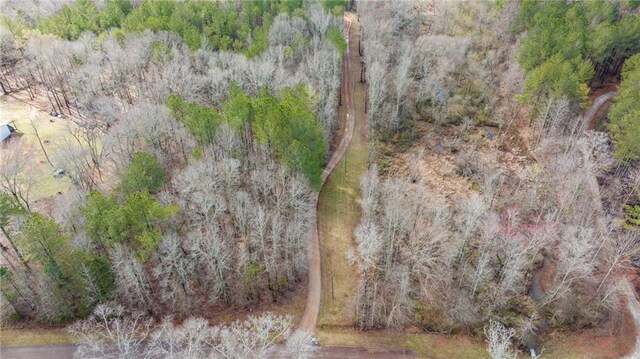 birds eye view of property with a view of trees