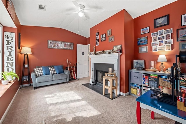 carpeted living area featuring visible vents, baseboards, a fireplace with flush hearth, lofted ceiling, and a ceiling fan