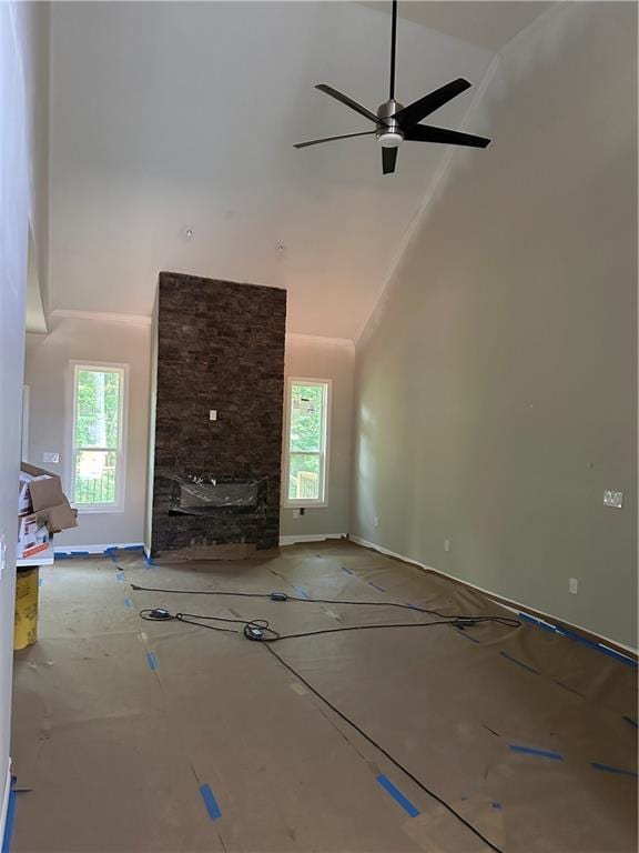 unfurnished living room featuring ceiling fan and high vaulted ceiling