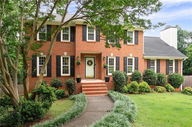 4497 Windsor Oaks Dr, Marietta, GA 30066 - colonial-style house with brick siding, a chimney, and roof with shingles