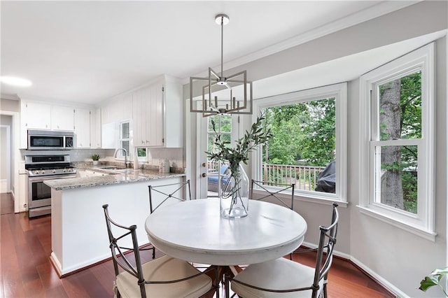 4497 Windsor Oaks Dr, Marietta, GA 30066 - dining area with dark wood-style flooring, crown molding, and a chandelier