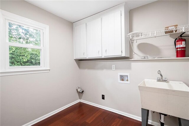 4497 Windsor Oaks Dr, Marietta, GA 30066 - washroom with cabinet space, dark wood-style floors, and washer hookup