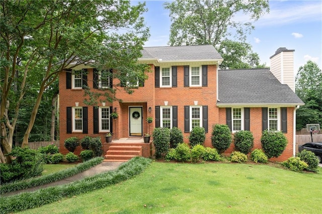 4497 Windsor Oaks Dr, Marietta, GA 30066 - colonial house featuring brick siding, a front lawn, and a chimney