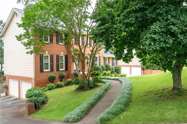 4497 Windsor Oaks Dr, Marietta, GA 30066 - colonial house featuring brick siding, a garage, asphalt driveway, and a front yard