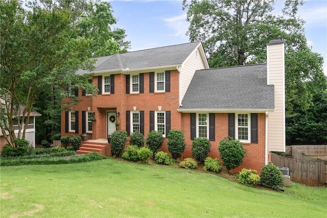 4497 Windsor Oaks Dr, Marietta, GA 30066 - colonial inspired home featuring a chimney, brick siding, and roof with shingles