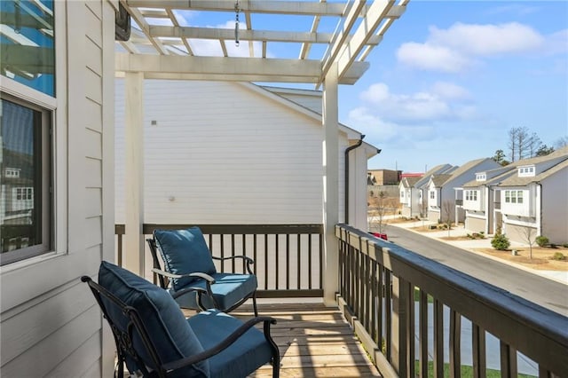 balcony featuring a residential view and a pergola