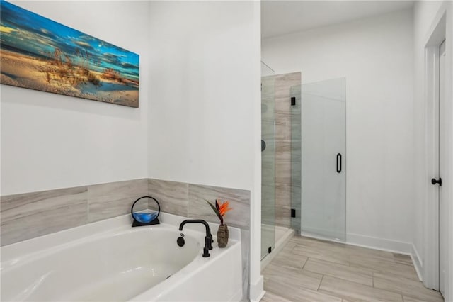 bathroom featuring a bath and a stall shower