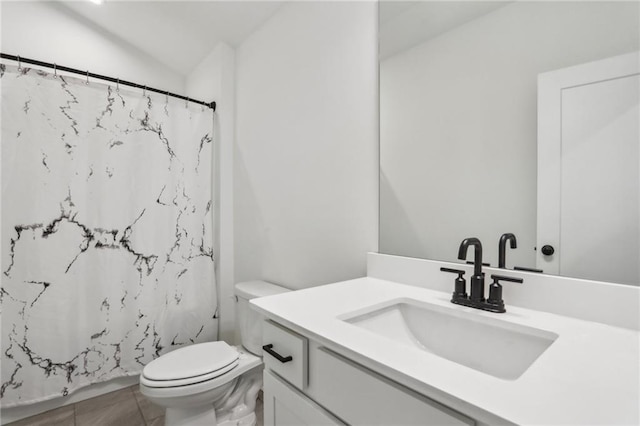 bathroom featuring vanity, lofted ceiling, toilet, and a shower with shower curtain