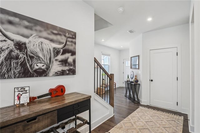 entryway with stairs, dark wood-type flooring, recessed lighting, and baseboards