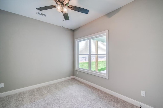 carpeted spare room featuring ceiling fan