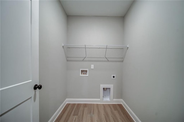 washroom featuring electric dryer hookup, hookup for a washing machine, and light hardwood / wood-style flooring