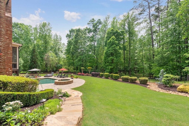 view of yard featuring an outdoor pool and a patio area