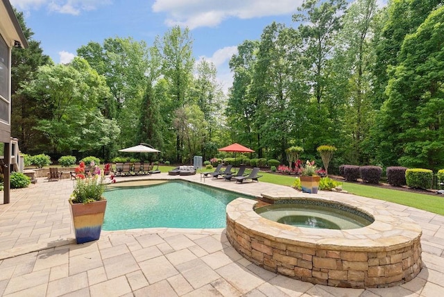 outdoor pool with a patio and an in ground hot tub