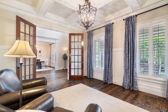 living area featuring crown molding, a notable chandelier, french doors, and coffered ceiling