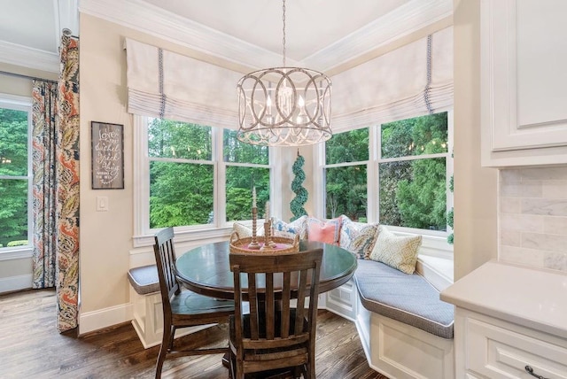 dining area featuring an inviting chandelier, ornamental molding, baseboards, and dark wood-style floors