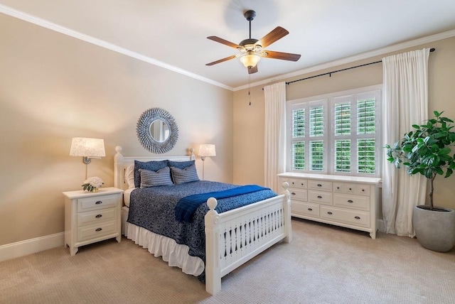 bedroom featuring baseboards, ornamental molding, light carpet, and a ceiling fan