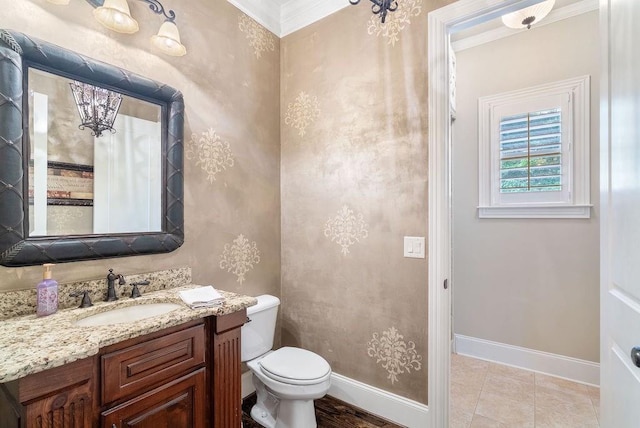 bathroom with baseboards, crown molding, toilet, and vanity