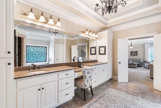 bathroom with a notable chandelier, vanity, baseboards, connected bathroom, and ornamental molding