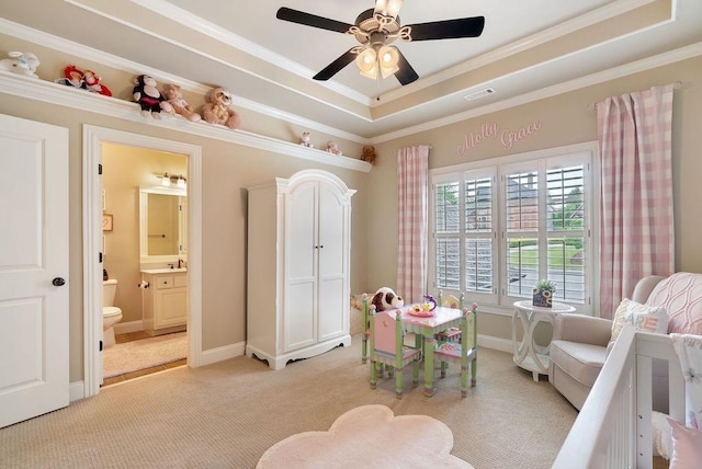 game room featuring crown molding, light colored carpet, a sink, a ceiling fan, and a tray ceiling