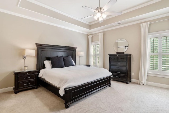 bedroom featuring a raised ceiling, visible vents, baseboards, and light colored carpet