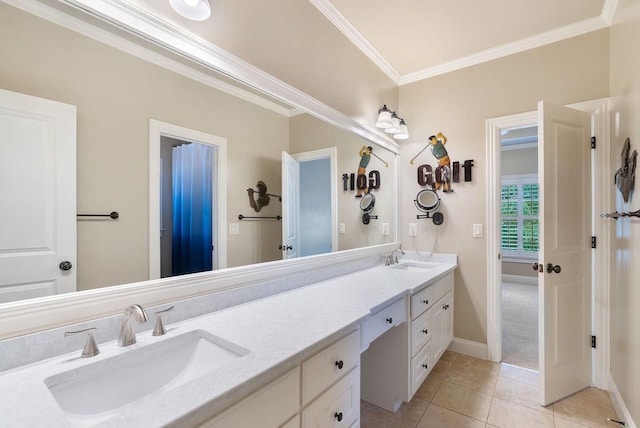 bathroom with a sink, baseboards, ornamental molding, and double vanity