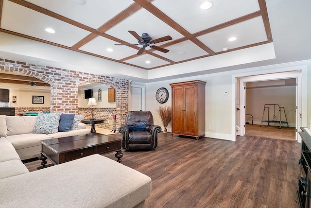 living room with baseboards, coffered ceiling, ceiling fan, and dark wood-style flooring