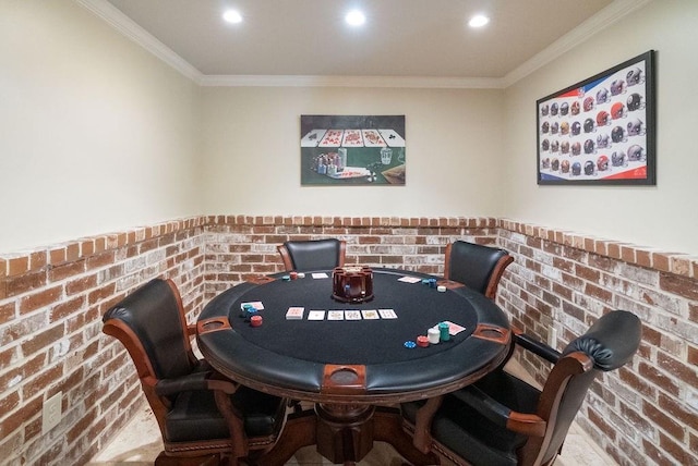 recreation room with crown molding, recessed lighting, a wainscoted wall, and brick wall