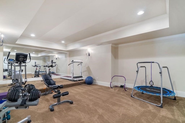 exercise room featuring a raised ceiling and baseboards