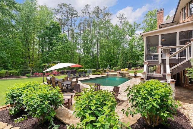 outdoor pool with a sunroom, outdoor dining area, stairway, and a patio