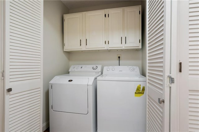 washroom featuring cabinet space and independent washer and dryer