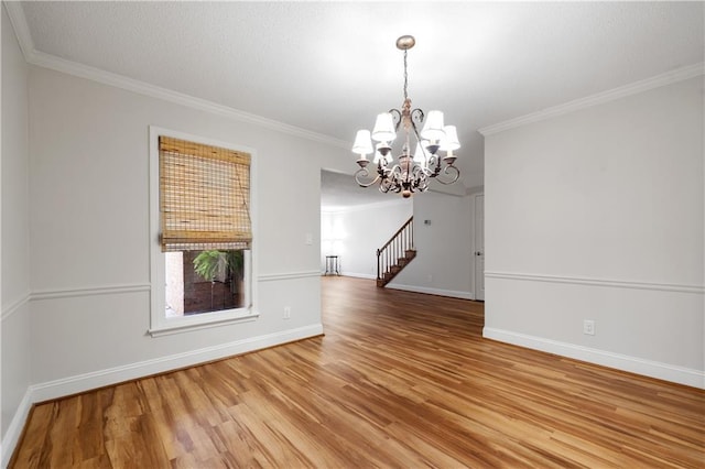 unfurnished dining area with light wood-type flooring, crown molding, stairway, and baseboards