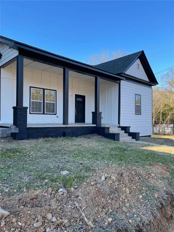 exterior space with a porch and a lawn