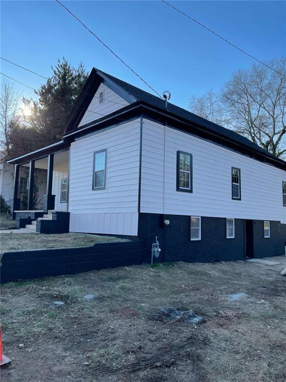 view of side of home with covered porch