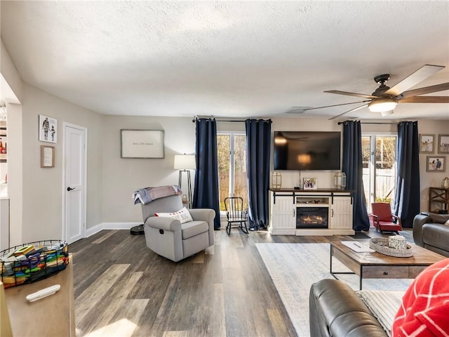 living room with a wealth of natural light, a fireplace, and hardwood / wood-style flooring