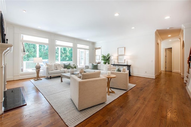 living room with hardwood / wood-style flooring and crown molding