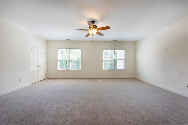 carpeted empty room featuring ornamental molding and ceiling fan