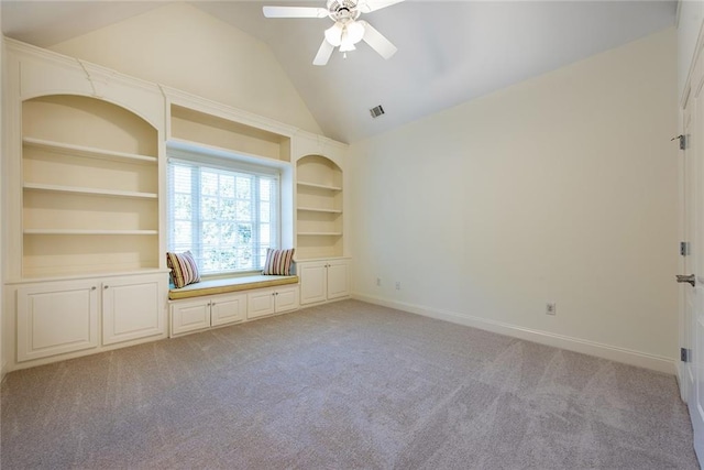 unfurnished living room with built in shelves, ceiling fan, light carpet, and lofted ceiling