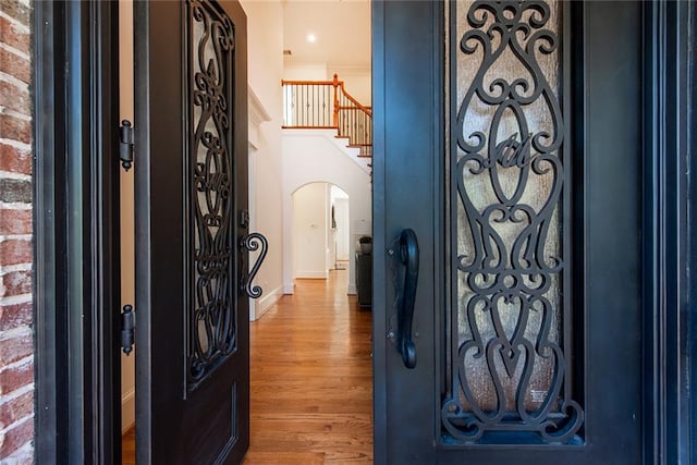 foyer featuring hardwood / wood-style flooring and ornamental molding