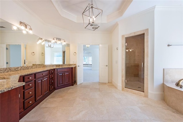 bathroom with a tray ceiling, shower with separate bathtub, vanity, and crown molding