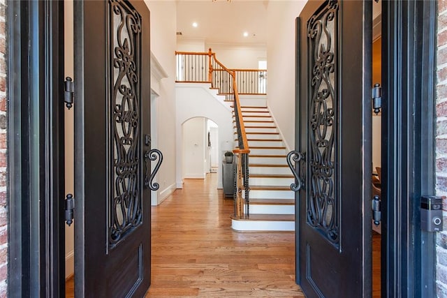 entrance foyer featuring light wood-type flooring and crown molding