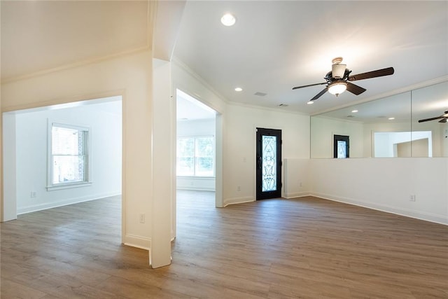 interior space featuring hardwood / wood-style floors, ceiling fan, and crown molding