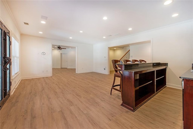 interior space with ceiling fan, light hardwood / wood-style flooring, and ornamental molding