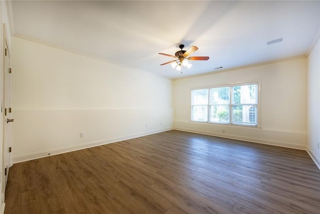 empty room featuring dark wood-type flooring, ceiling fan, and crown molding