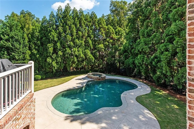 view of pool featuring an in ground hot tub and a patio area