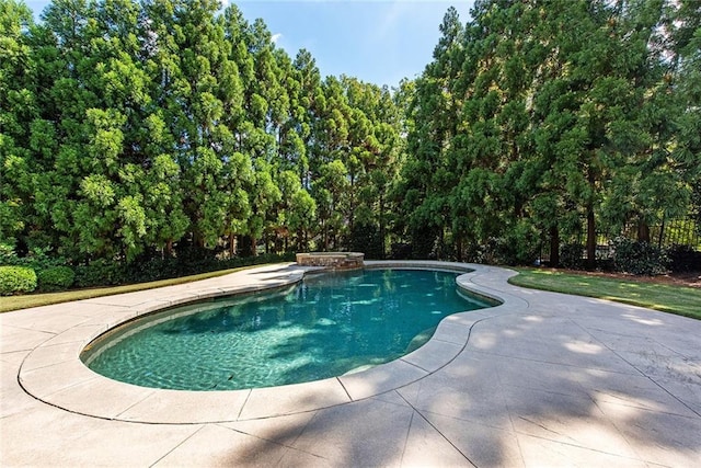 view of pool featuring a hot tub and a patio area