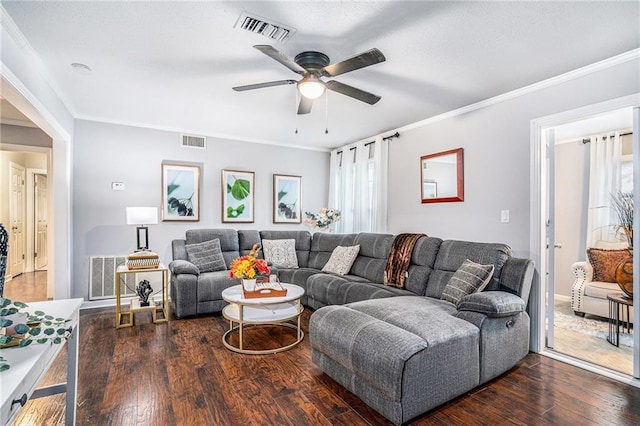 living room featuring crown molding, ceiling fan, and dark wood-type flooring