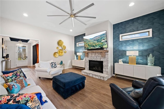 living room featuring wood finished floors, recessed lighting, wallpapered walls, baseboards, and an accent wall