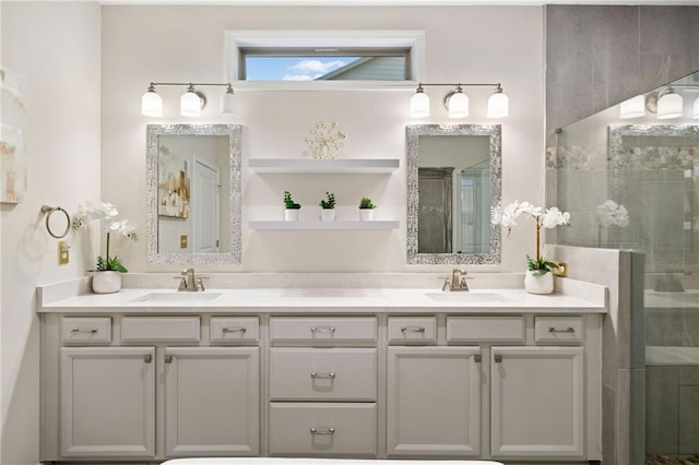 full bathroom with a sink, double vanity, and a shower stall