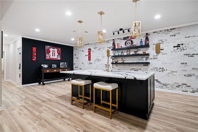 bar featuring hanging light fixtures, recessed lighting, light wood-type flooring, and ornamental molding